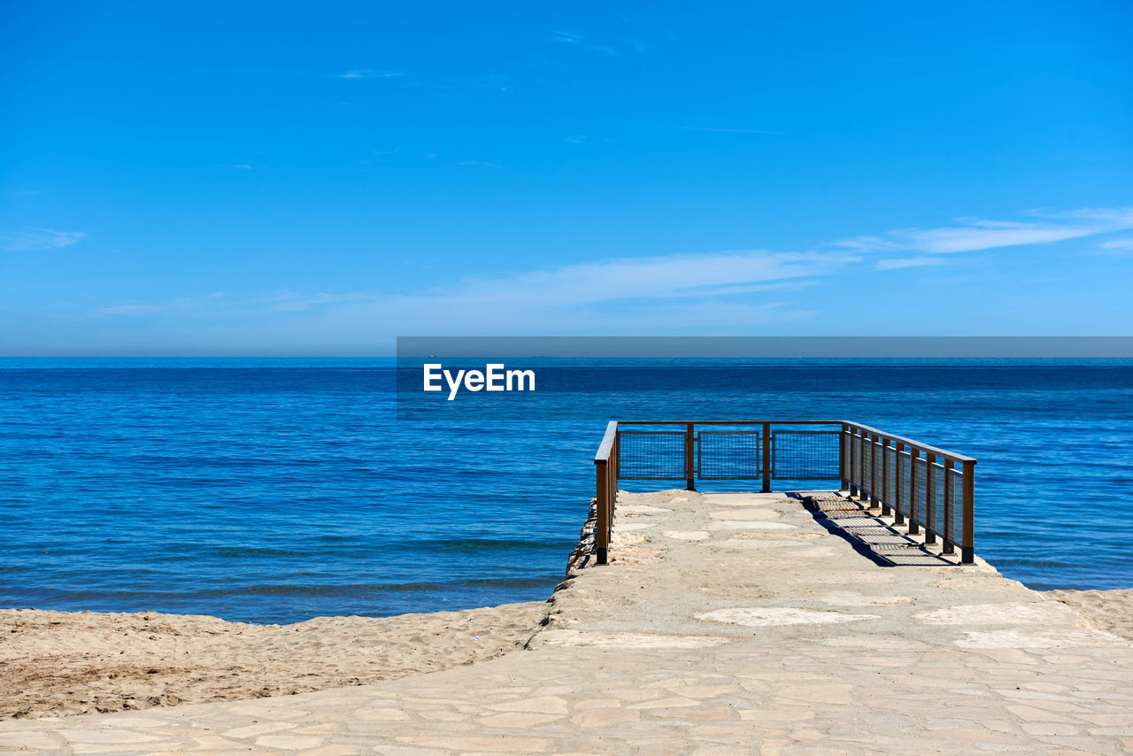 Scenic view of sea against blue sky