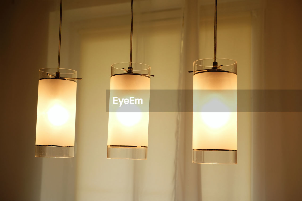 light fixture, lighting equipment, lighting, illuminated, lamp, indoors, light, hanging, glowing, no people, electric lamp, electricity, light - natural phenomenon, electric light, wall - building feature, ceiling, light bulb, home interior, domestic room, interior design