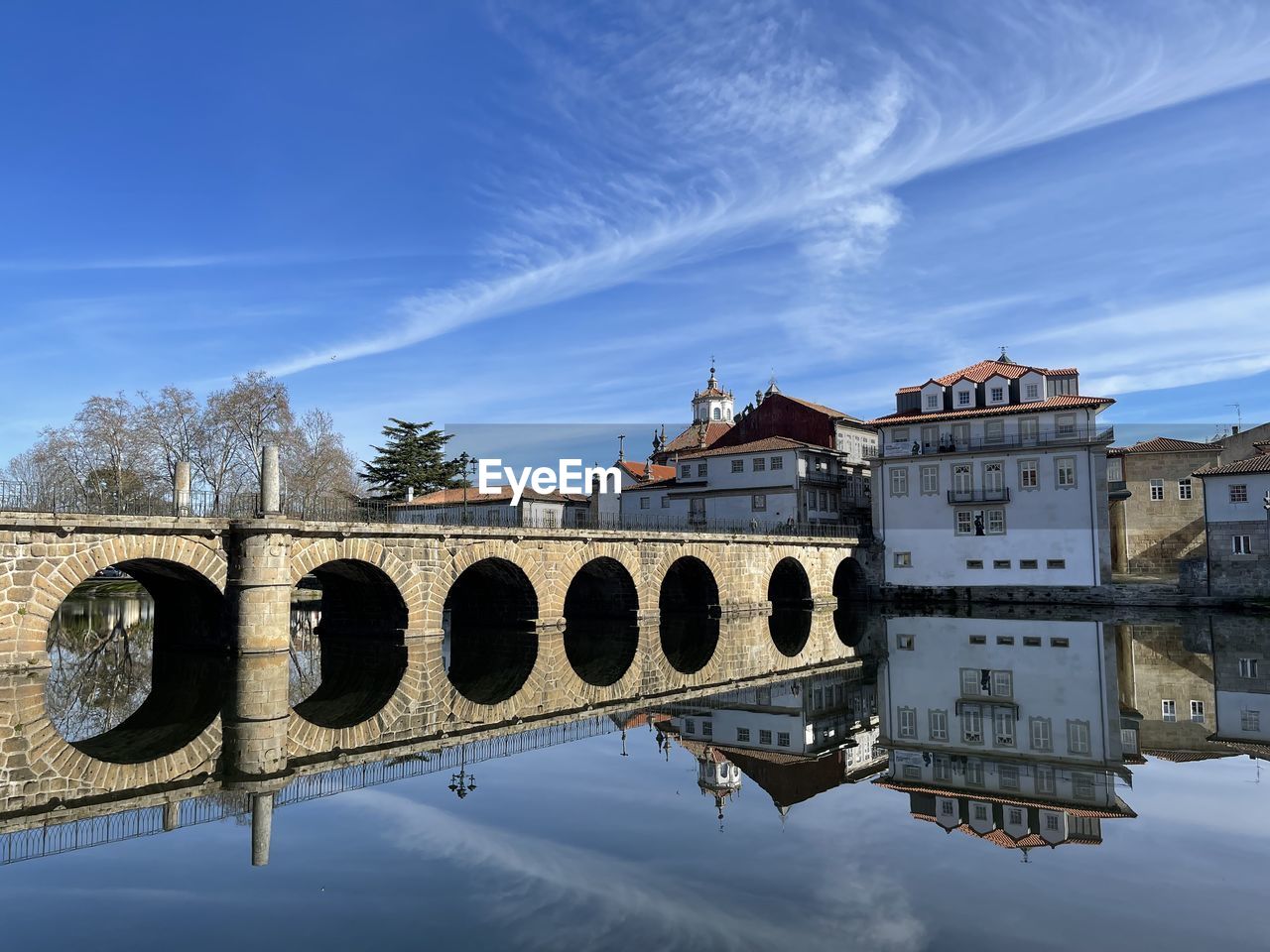 architecture, water, built structure, reflection, sky, nature, building exterior, travel destinations, bridge, arch, blue, cloud, city, travel, landmark, history, river, the past, no people, building, tourism, transportation, outdoors, day, landscape