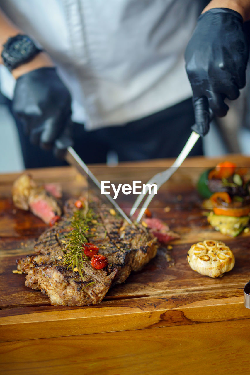 Midsection of man preparing food on table