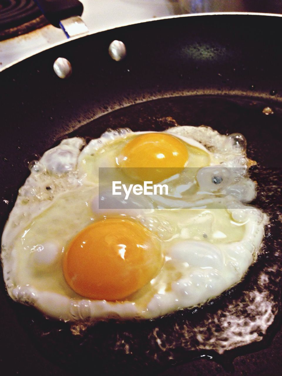 Close-up of making egg in frying pan