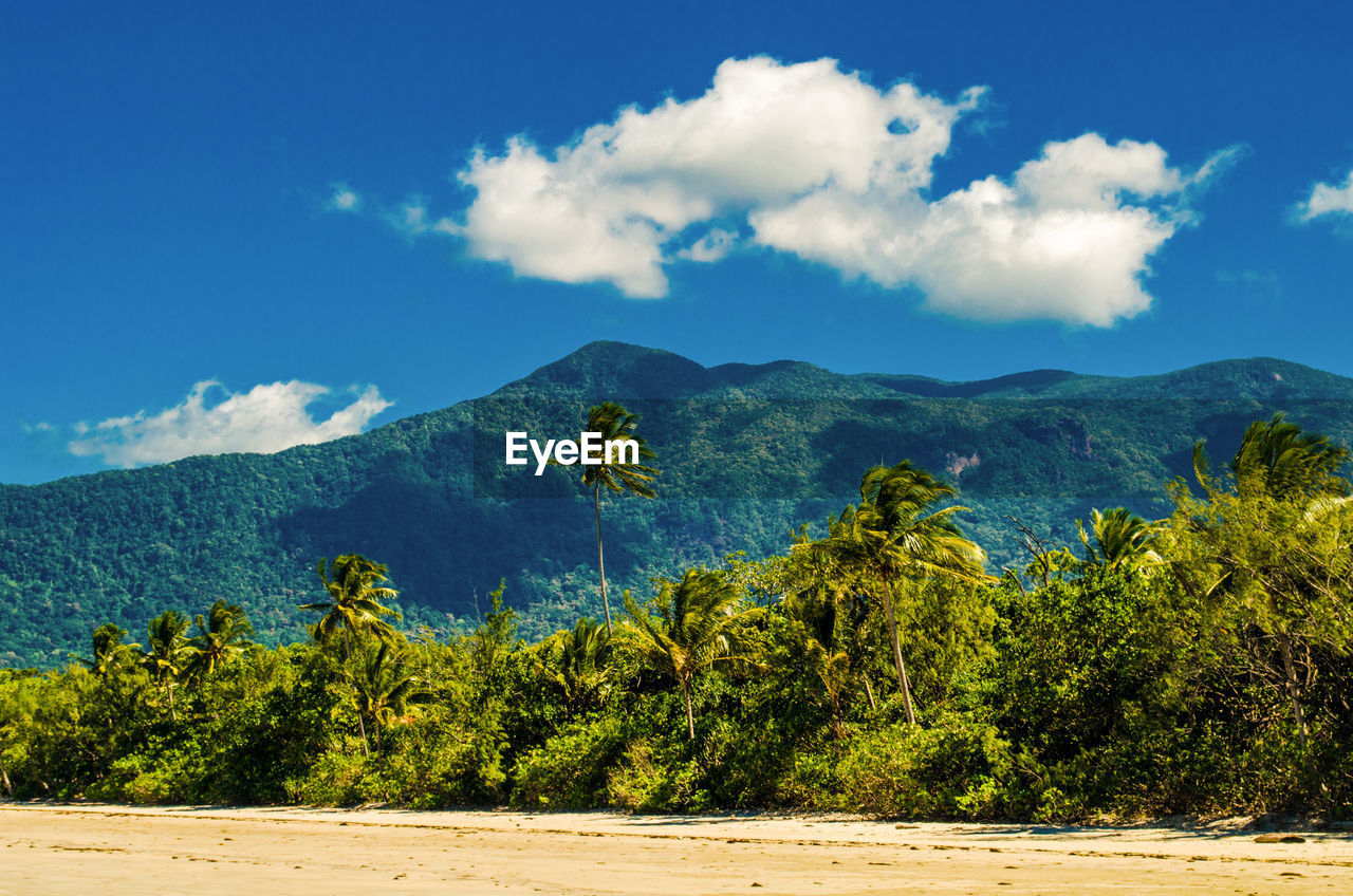 Scenic view of mountains against blue sky