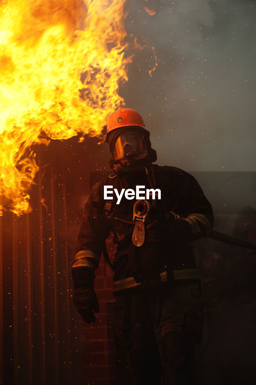 Firefighter in front of building on fire