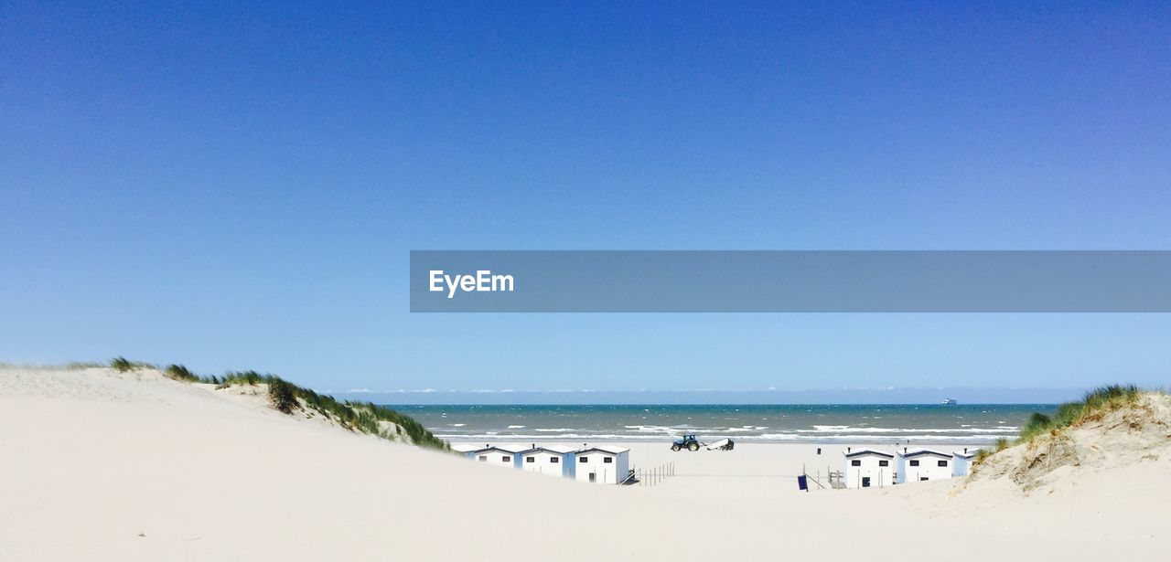 PANORAMIC SHOT OF BEACH AGAINST CLEAR BLUE SKY