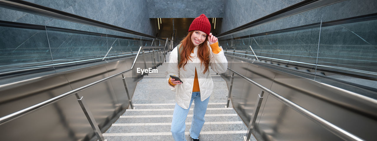 rear view of woman walking in subway