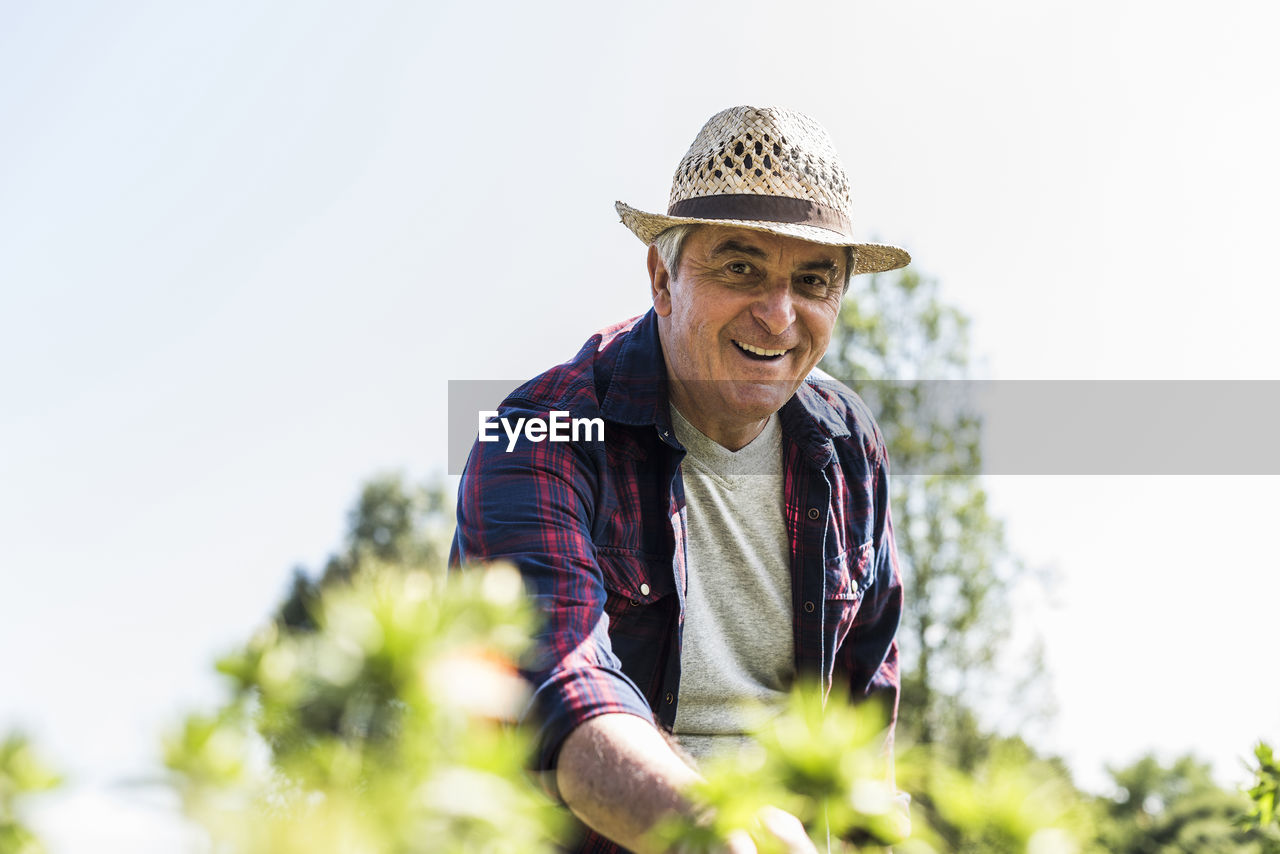 Portrait of smiling senior man in garden