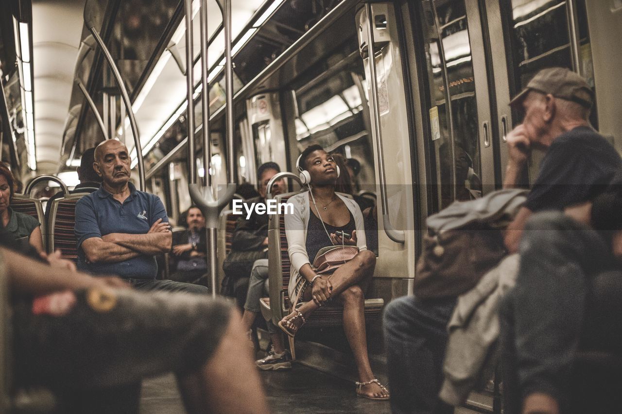 GROUP OF PEOPLE SITTING ON TRAIN