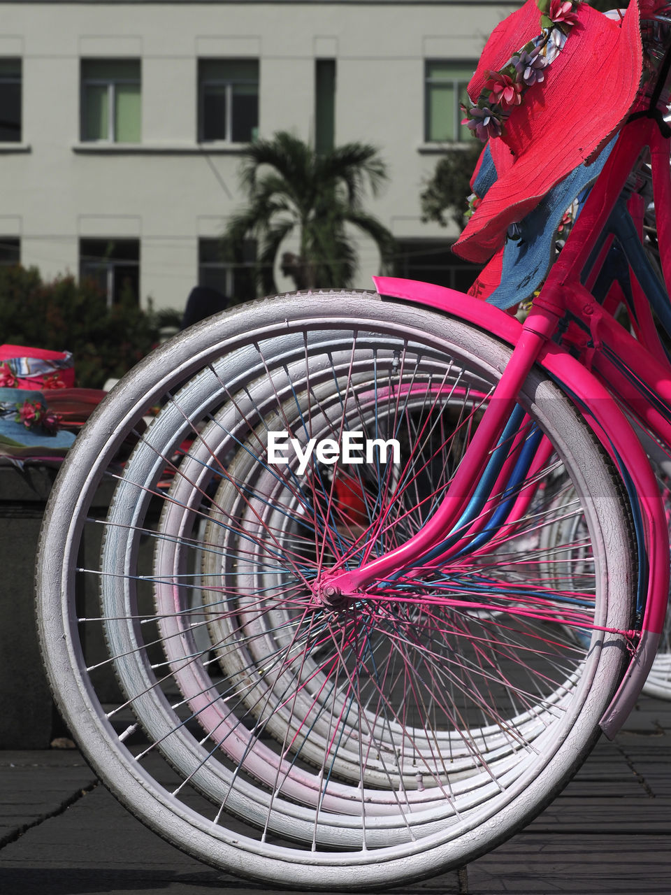 CLOSE-UP OF BICYCLE PARKED BY BUILDING