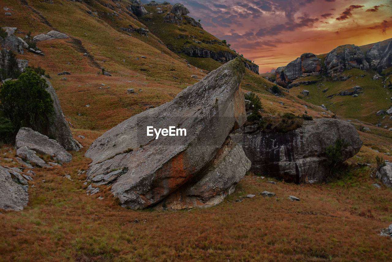 Scenic view of land against sky during sunset