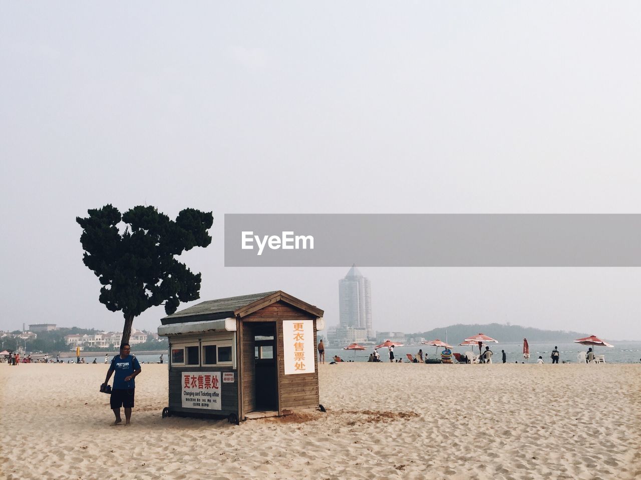 PEOPLE ON BEACH AGAINST SKY