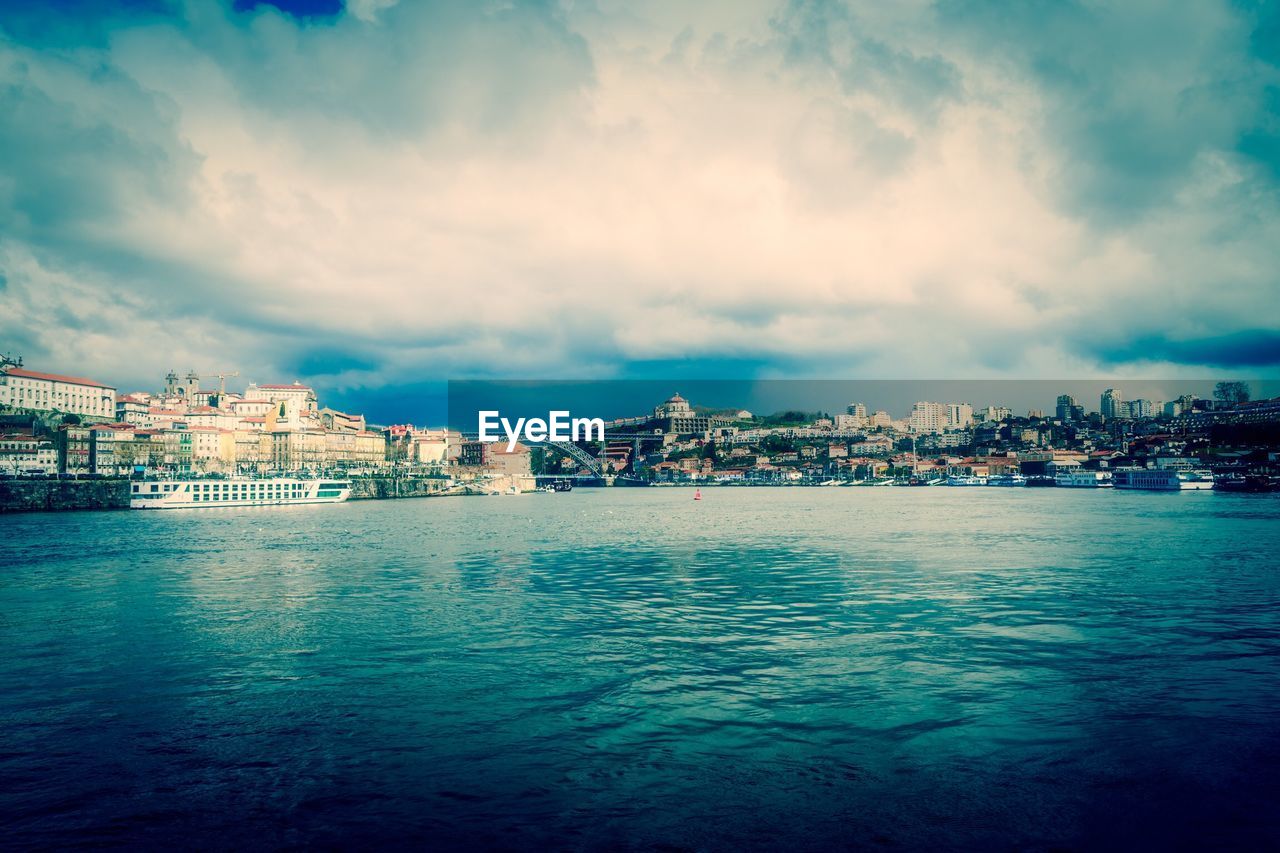 SEA AND TOWNSCAPE AGAINST SKY