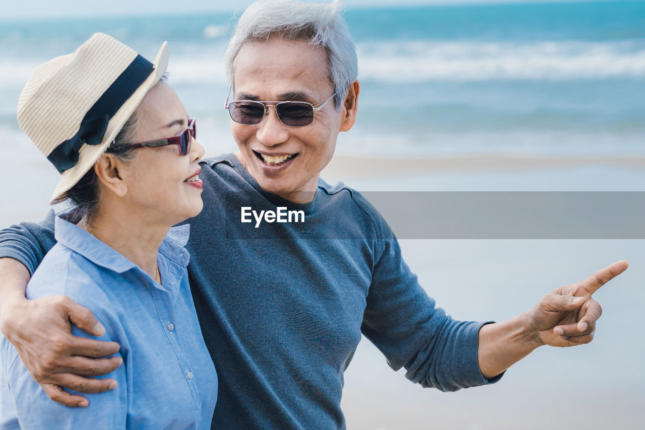 MAN AND WOMAN WEARING SUNGLASSES AT SEA