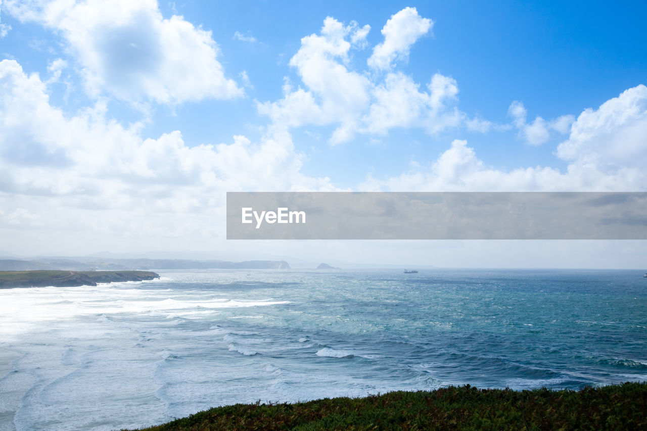 sky, sea, water, horizon, cloud, scenics - nature, body of water, land, ocean, beauty in nature, beach, nature, environment, shore, landscape, coast, horizon over water, blue, travel, tranquility, travel destinations, no people, outdoors, day, tranquil scene, coastline, tourism, wave, seascape, cloudscape, urban skyline, wind wave, trip, holiday, idyllic, vacation, bay, summer, panoramic, non-urban scene, island, motion, water's edge