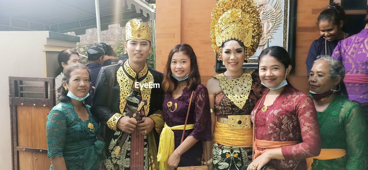 GROUP OF PEOPLE IN TRADITIONAL CLOTHING STANDING IN STORE