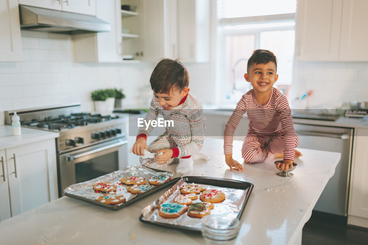 Cute kids preparing cookies at home