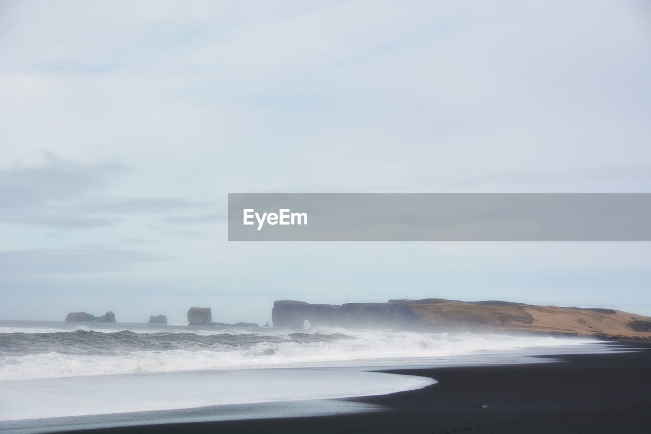 Scenic view of waves breaking on shore