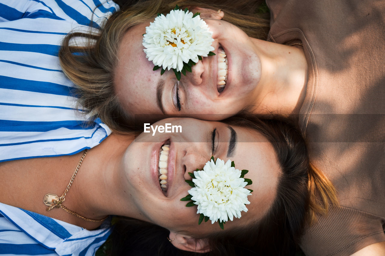 Portrait of beautiful woman with white flower