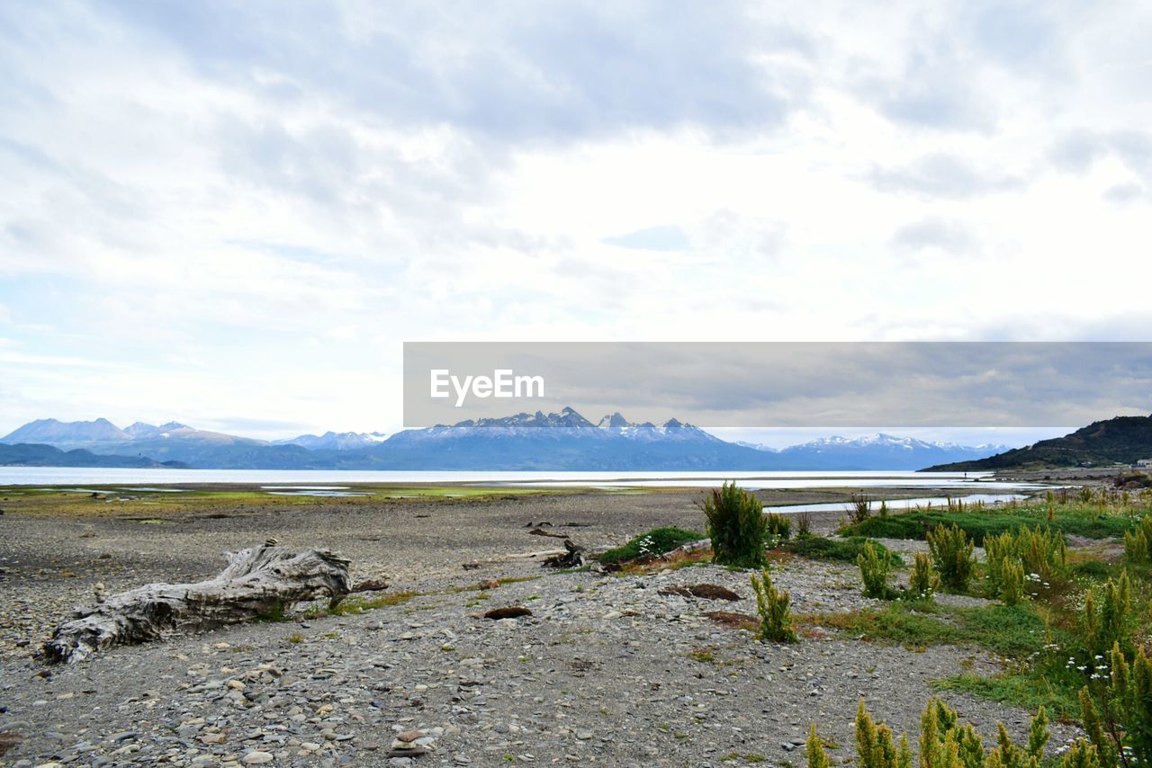 SCENIC VIEW OF LAND AND MOUNTAINS AGAINST SKY