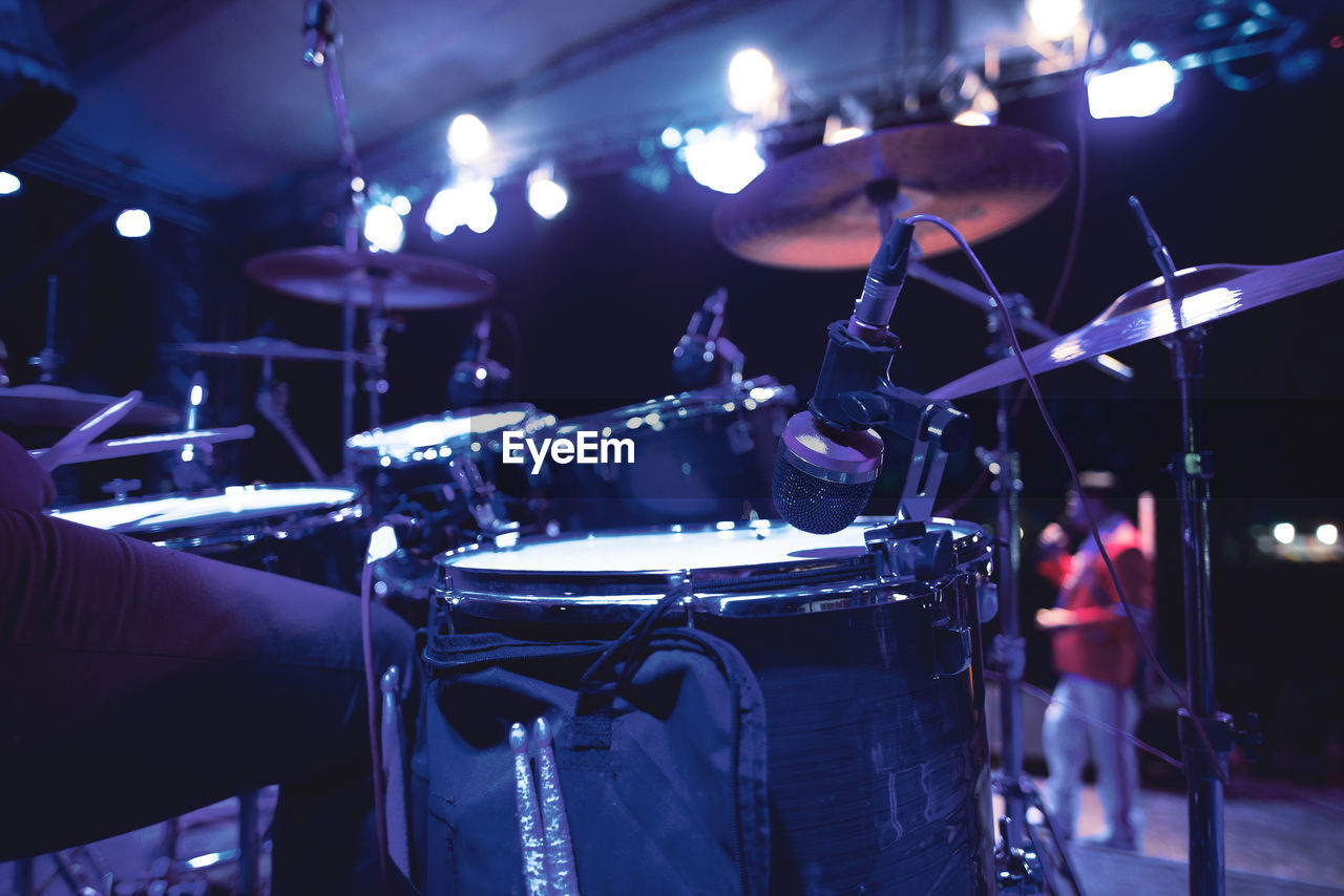 Midsection of person playing drum in event