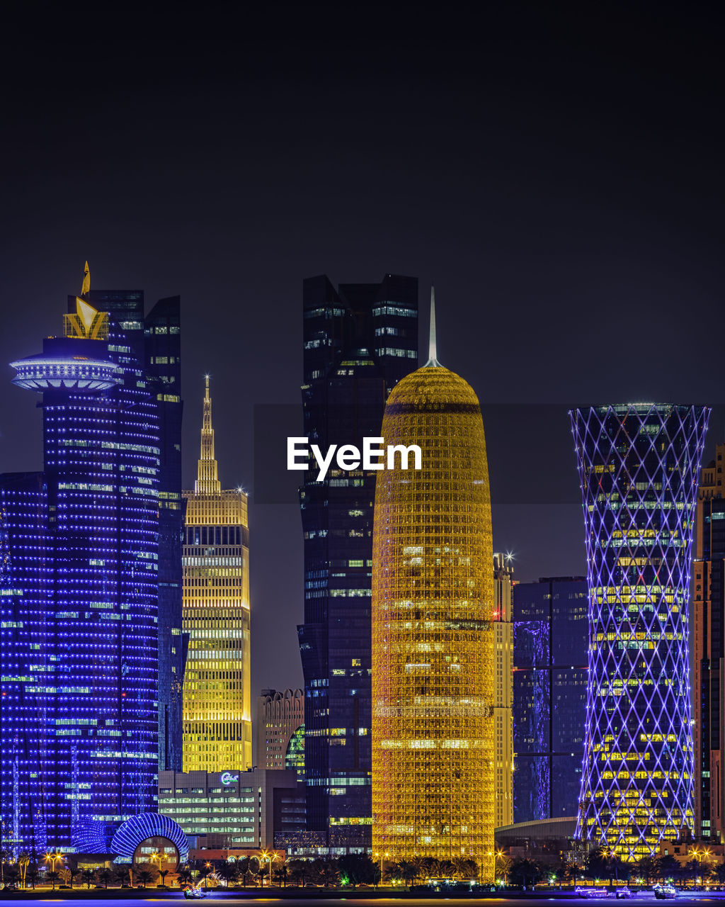 Illuminated buildings against sky at night