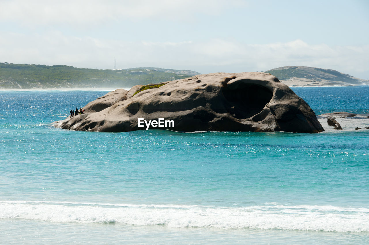 ROCK IN SEA AGAINST SKY