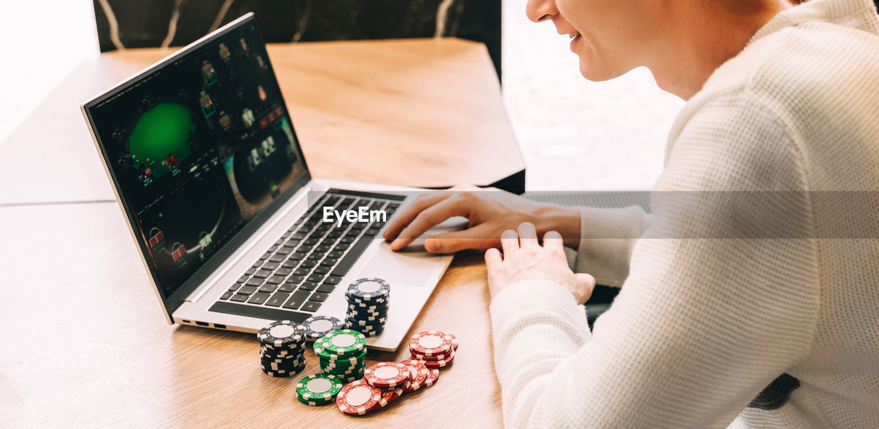 midsection of man using laptop at table