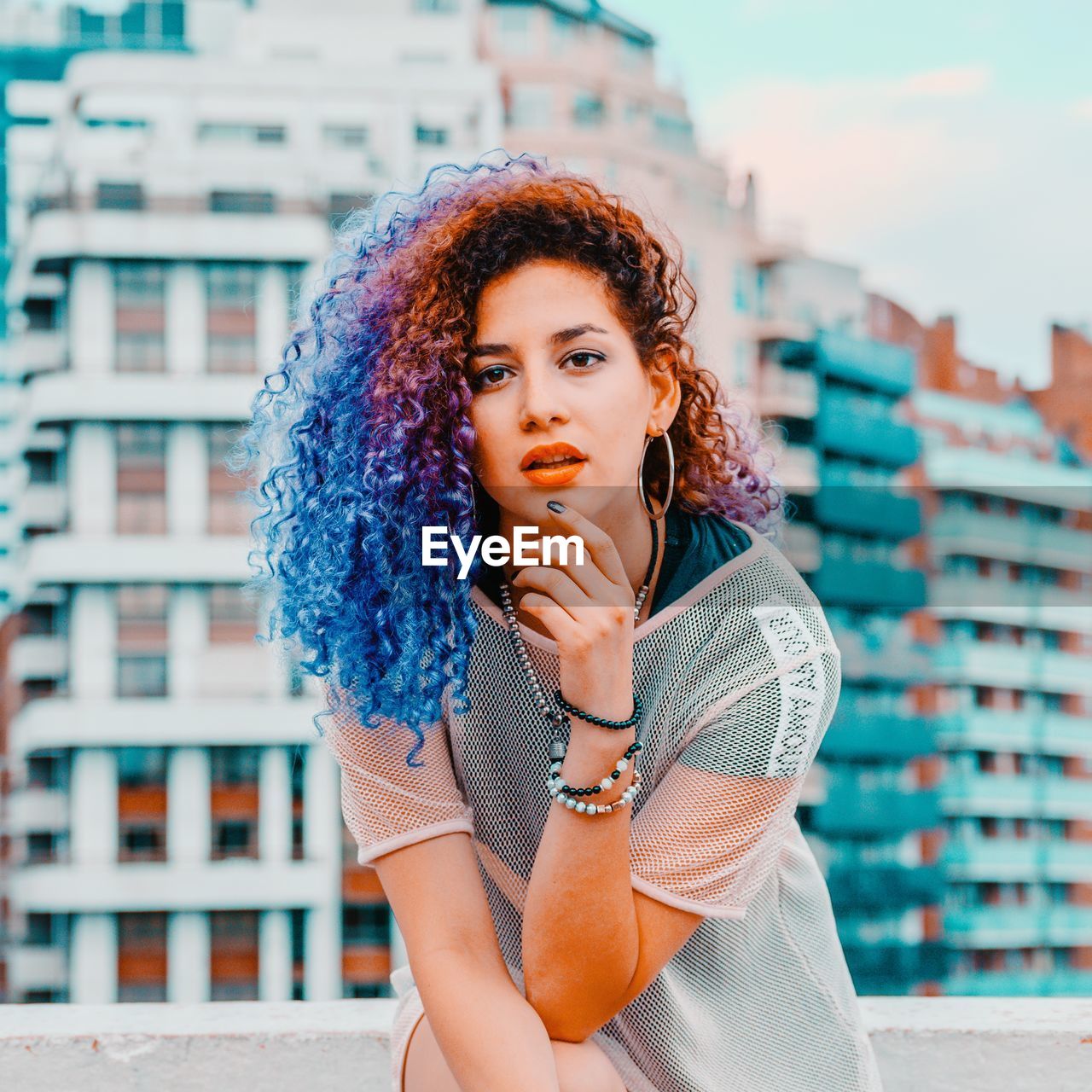 Close-up portrait of beautiful young woman in city