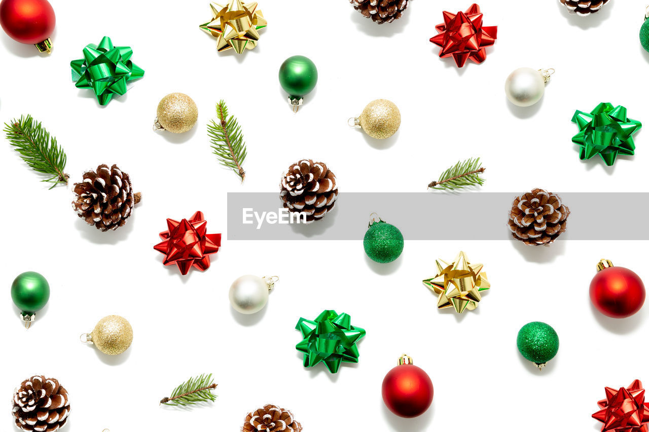 Directly above shot of christmas ornaments over white background