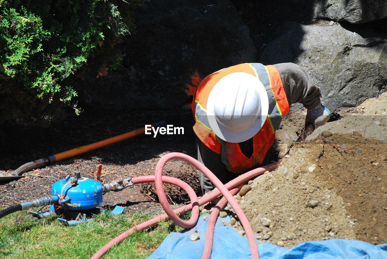 High angle view of man working on rock