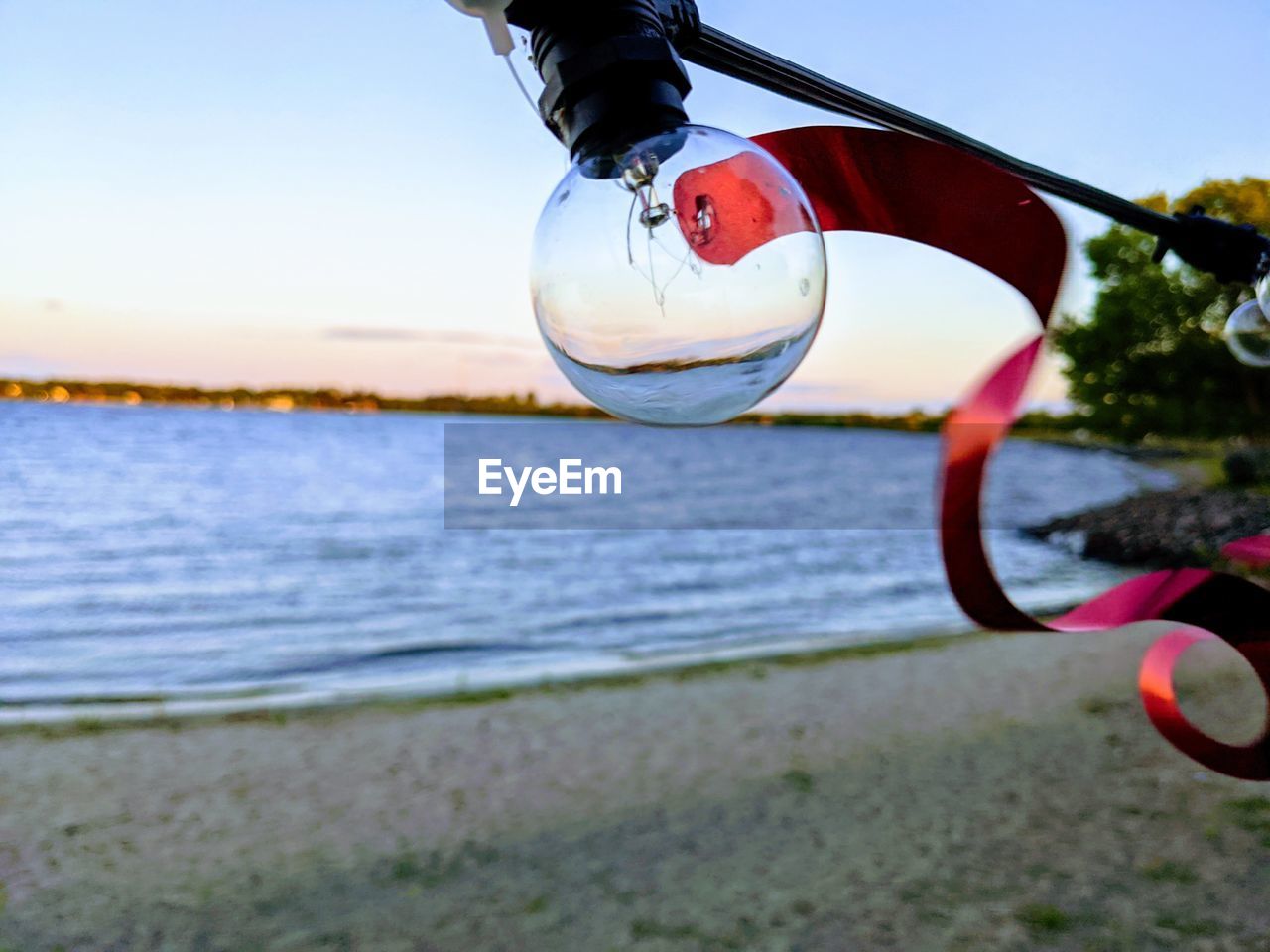 CLOSE-UP OF SUNGLASSES ON BEACH