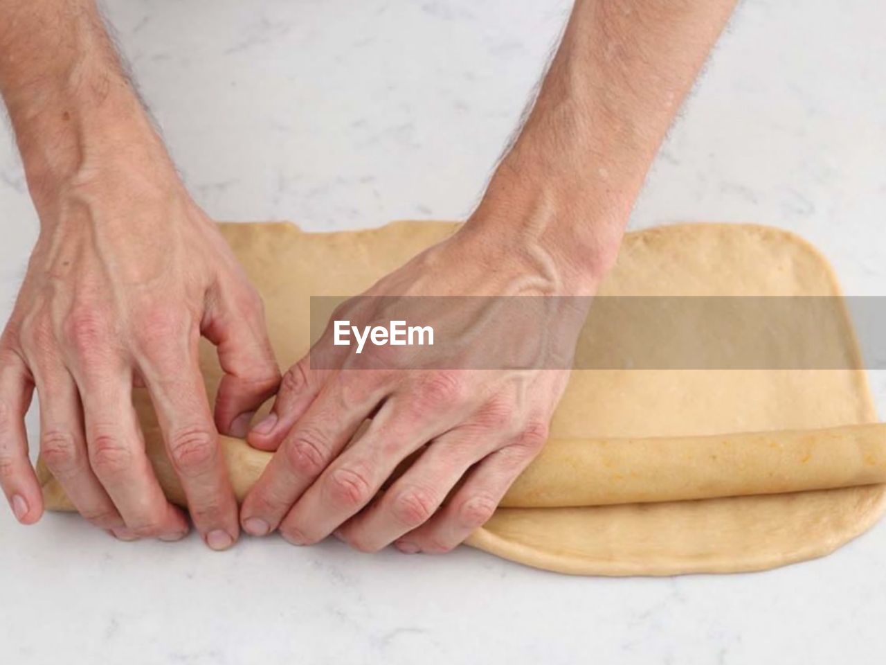 cropped hands of man working at table