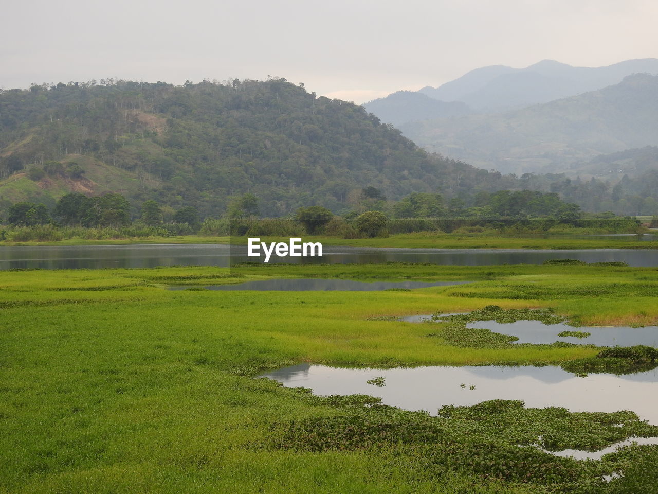 SCENIC VIEW OF LAKE AGAINST MOUNTAIN