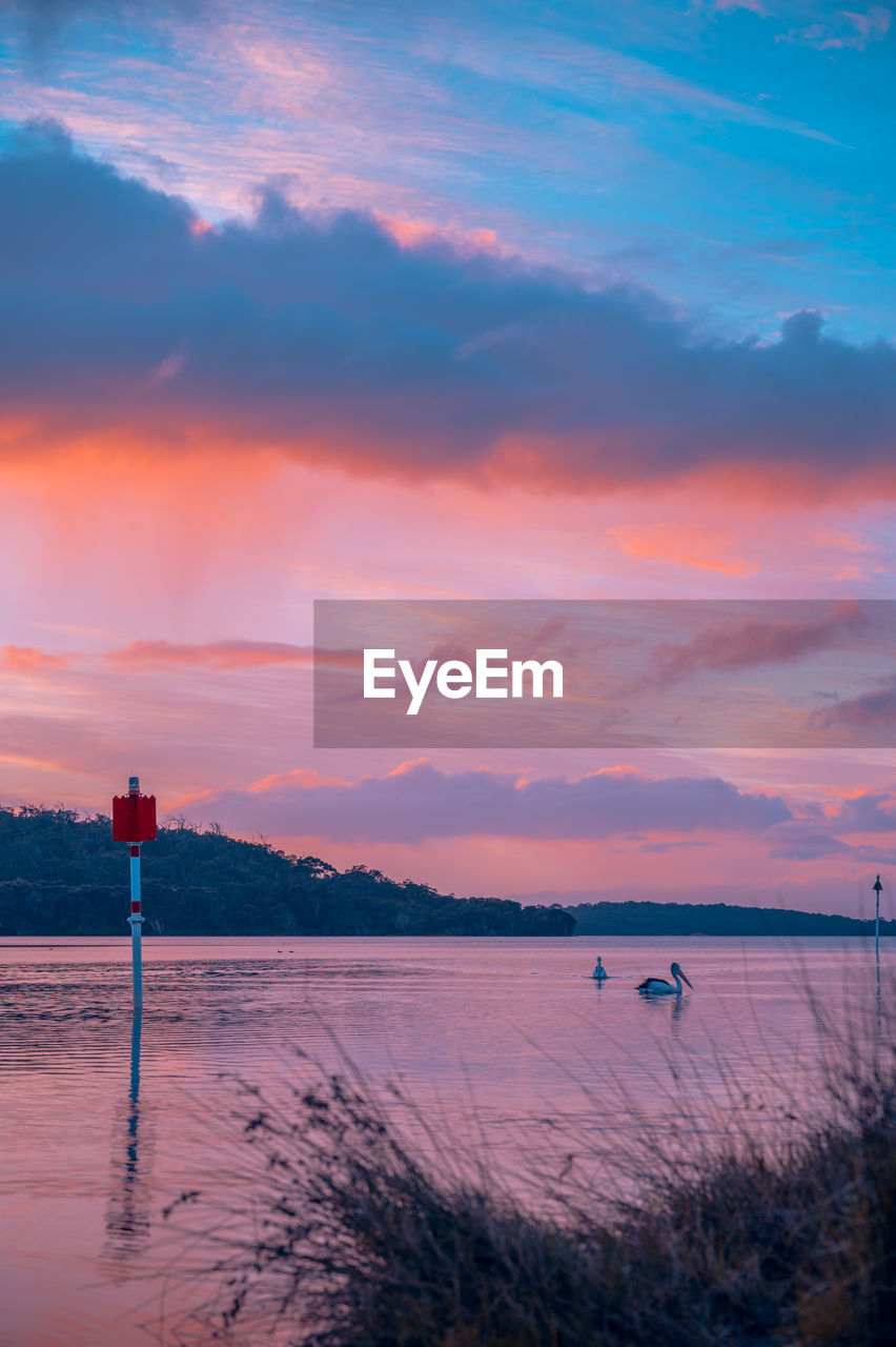 Scenic view of beach against sky during sunset