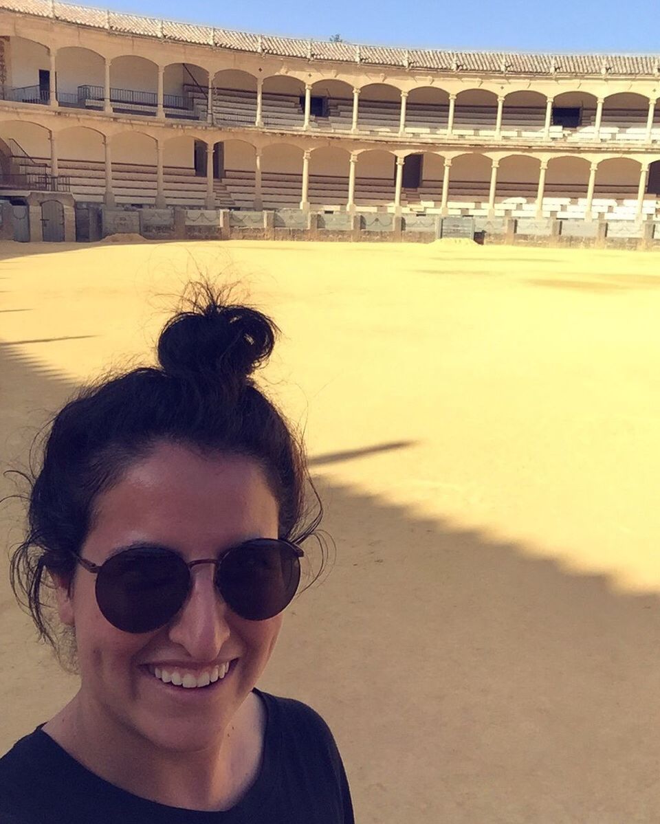 Close-up of happy woman standing on ground in stadium