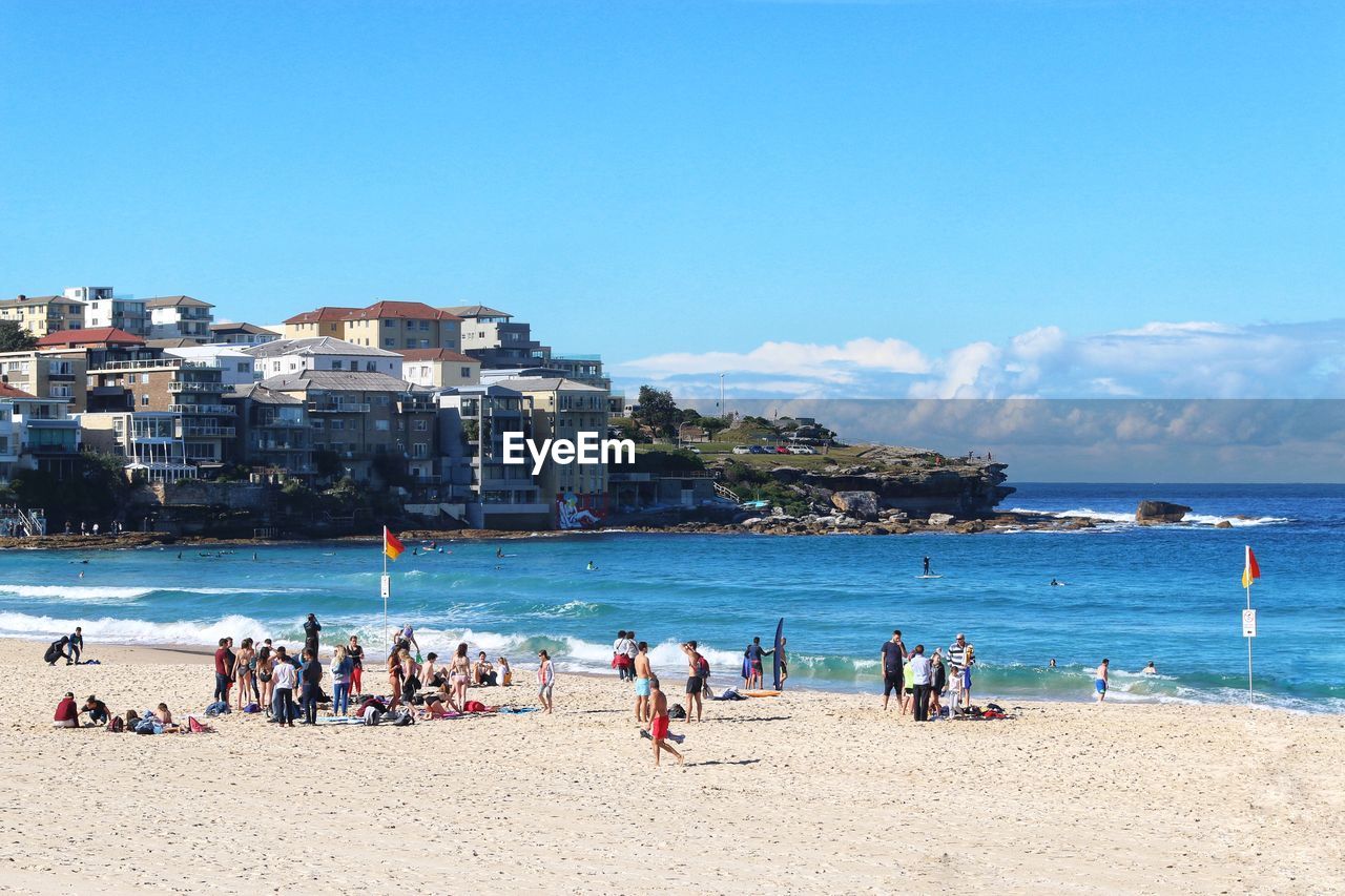 People at bondi beach against blue sky and beautiful sunny day background 