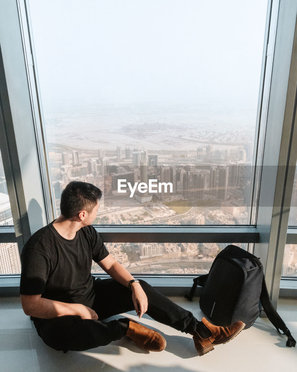 Man looking through window