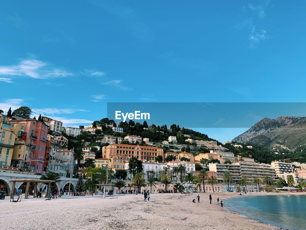 City skyline of menton on the french riviera, on a sunny day and from the harbor, blue sky 