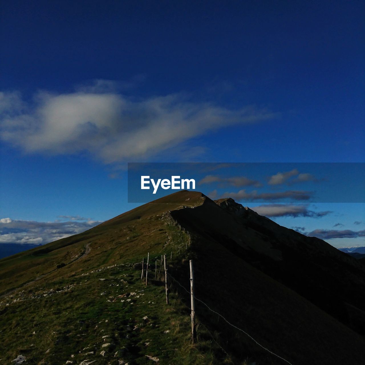 Low angle view of mountain against blue sky