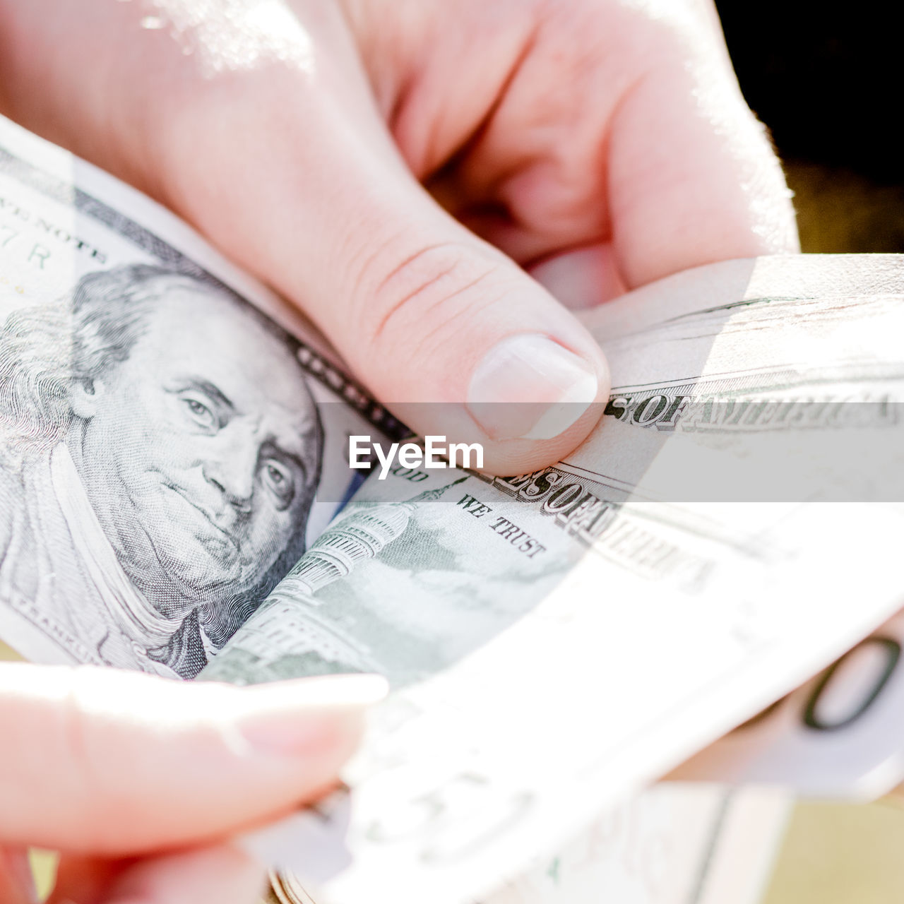 cropped hand of man holding paper currency