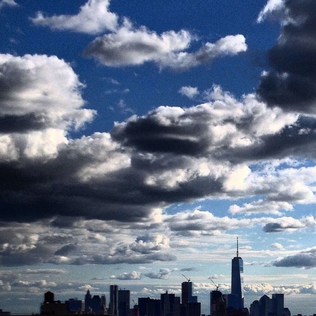 SKYSCRAPERS AGAINST CLOUDY SKY