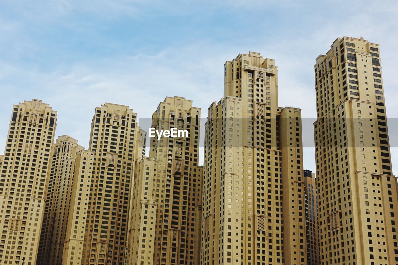 Low angle view of modern buildings in city against sky