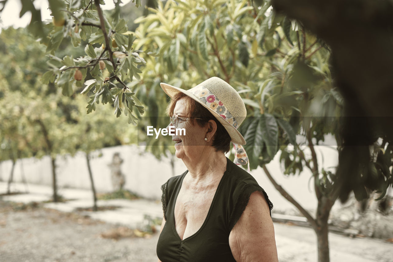 Close-up of a smiling grandmother in her urban garden