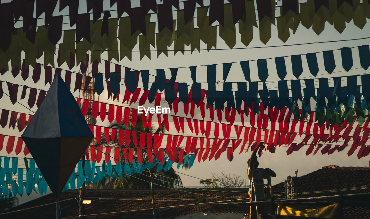 ROW OF FLAGS HANGING ON WOODEN WALL