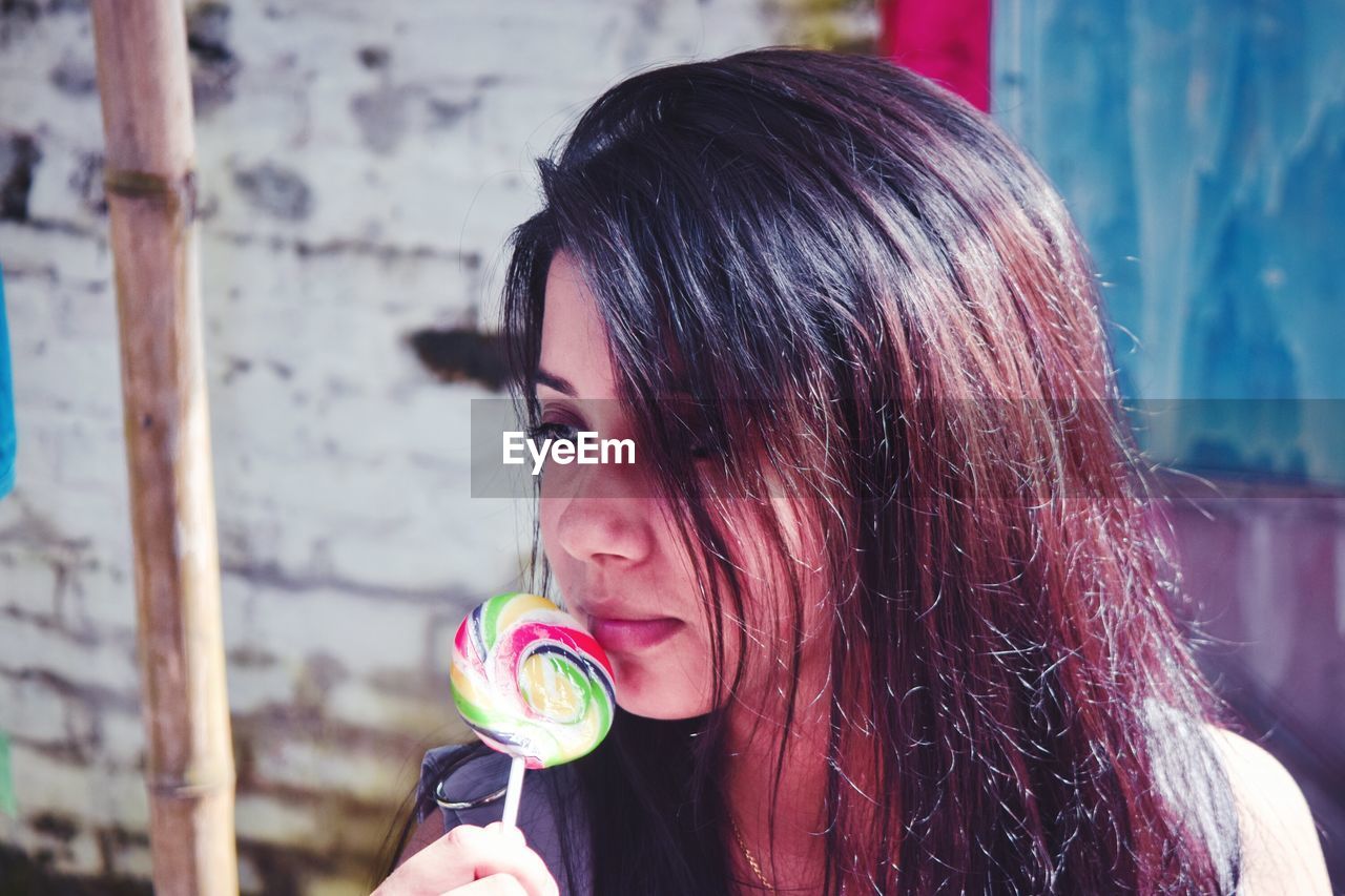 Close-up of beautiful woman with lollipop