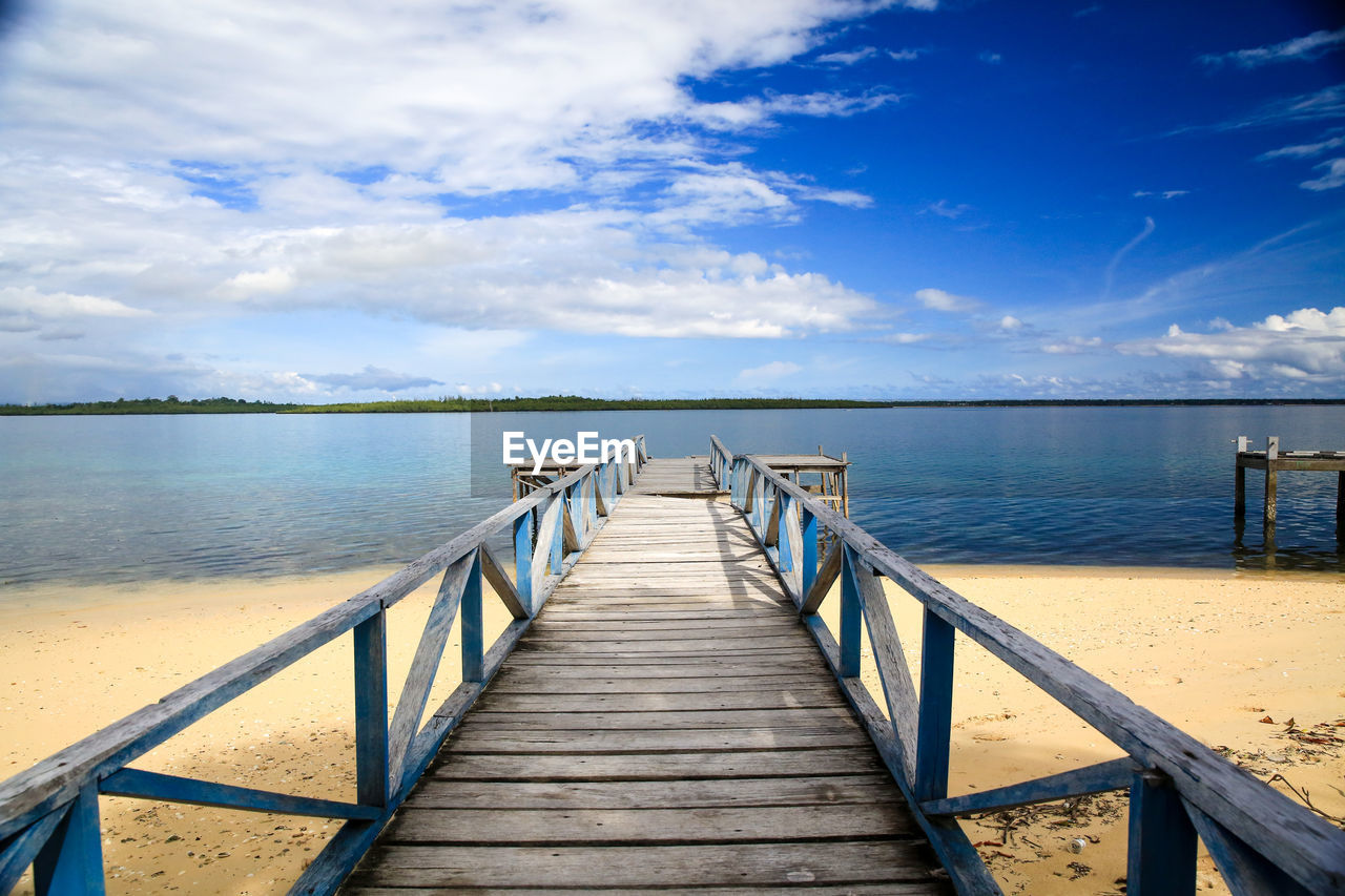 Pier over sea against sky