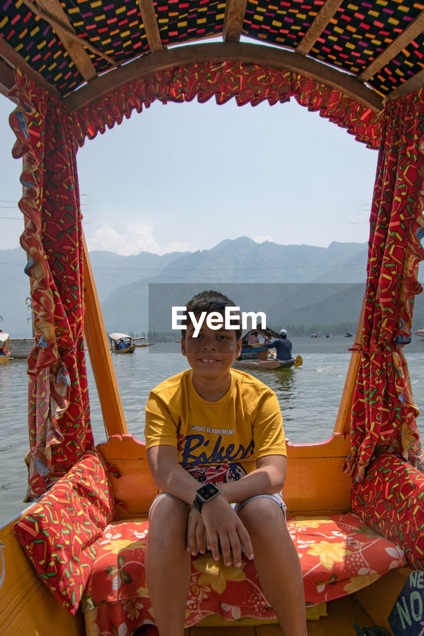 Portrait of boy sitting on boat