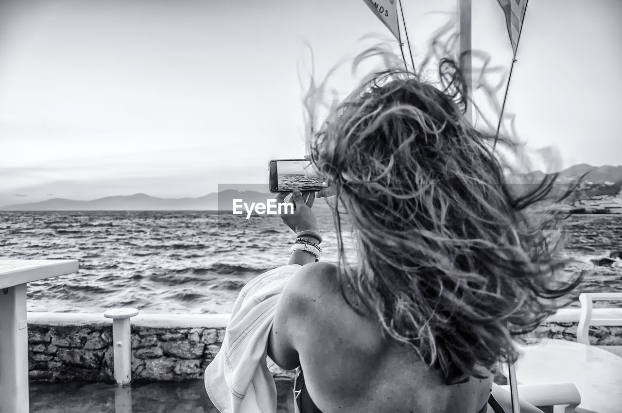 PORTRAIT OF WOMAN AGAINST SEA