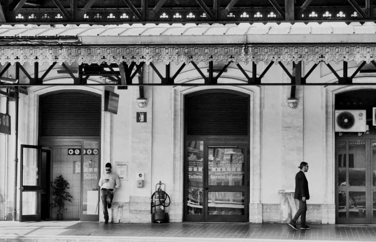 PEOPLE STANDING IN FRONT OF BUILDING