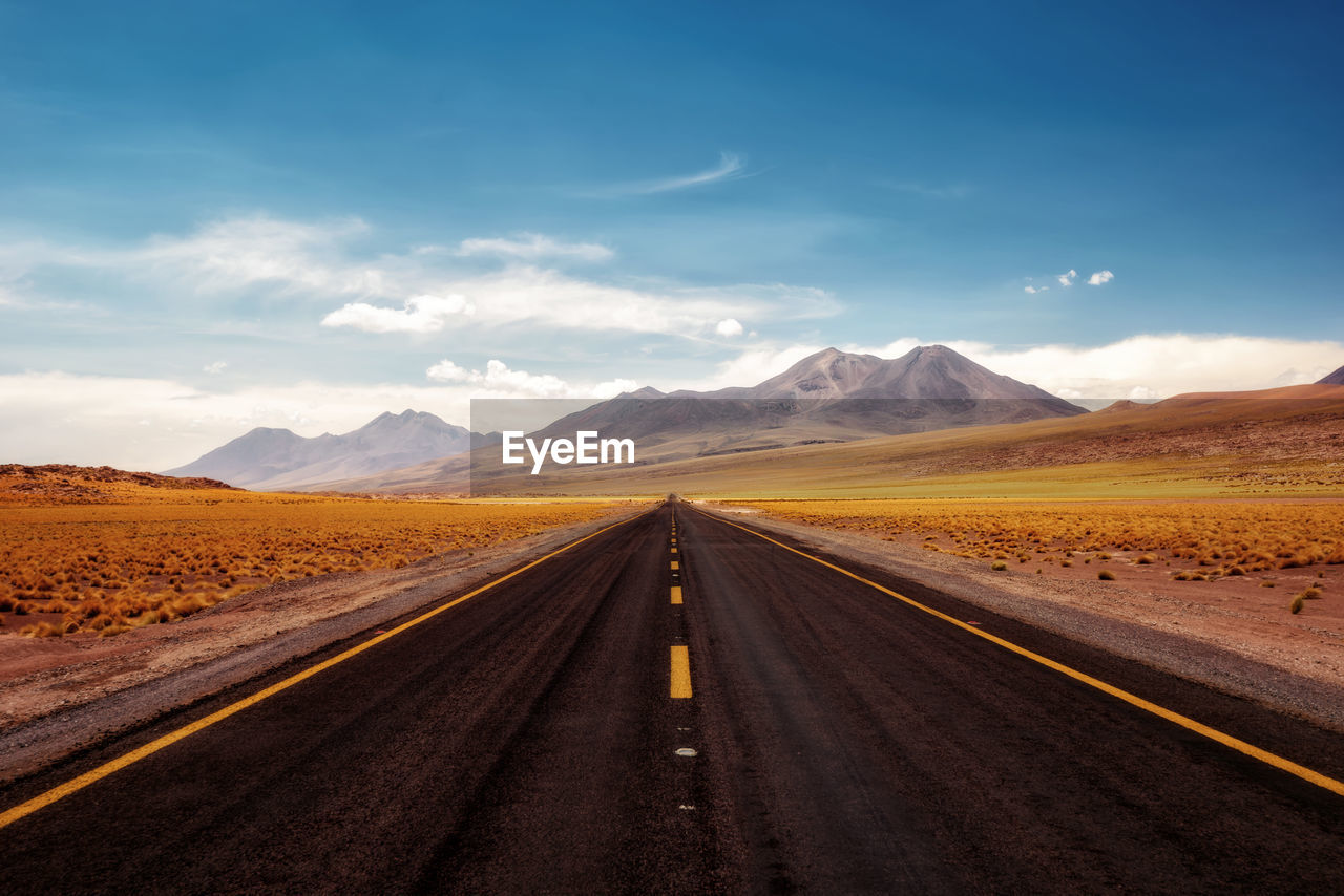 Empty road along countryside landscape