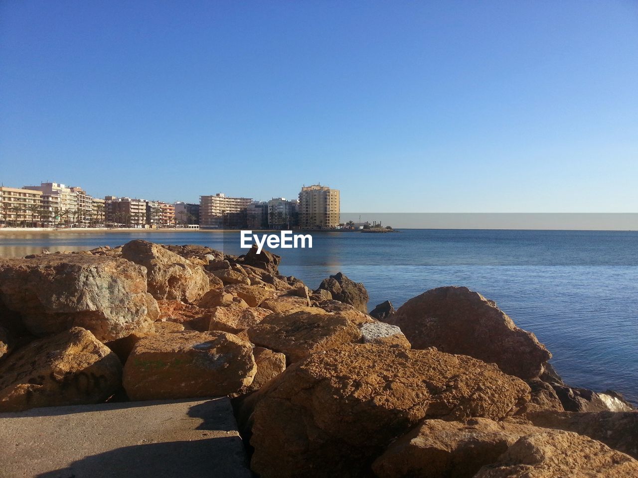 Scenic view of sea against clear blue sky